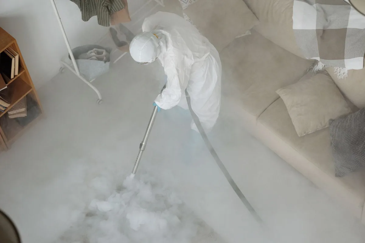 Biohazard cleanup technician in protective equipment, California, MO